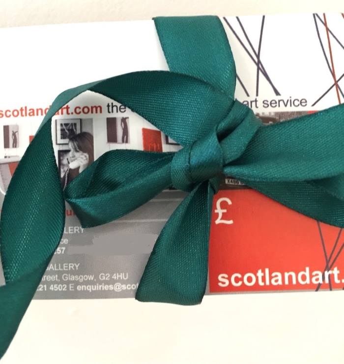 A gift voucher redeemable for art at Scotland Art gallery, presented wrapped with a bow.